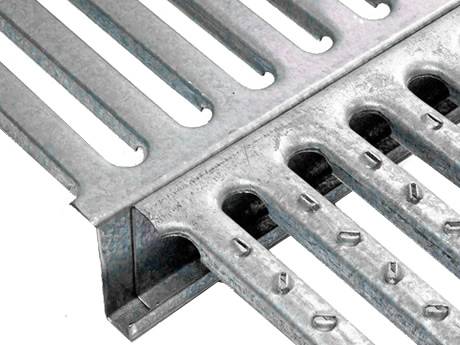 Interlocking safety gratings available in smooth surface and perforated button surface.